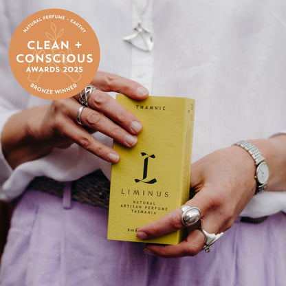 Hands holding a box of Thamnic natural perfume - with bronze medal rosette 2025 clean and conscious.  Credit: Jess Oakenfull