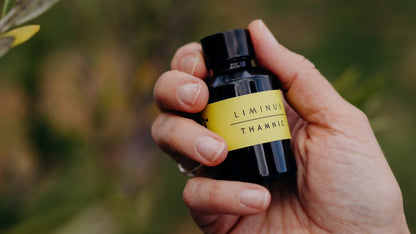 Thamnic natural perfume refill bottle - Liminus, held by a hand.  Credit Jess Oakenfull